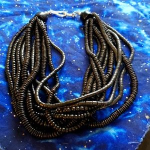 Big and bold multistrand black natural wood beads necklace.